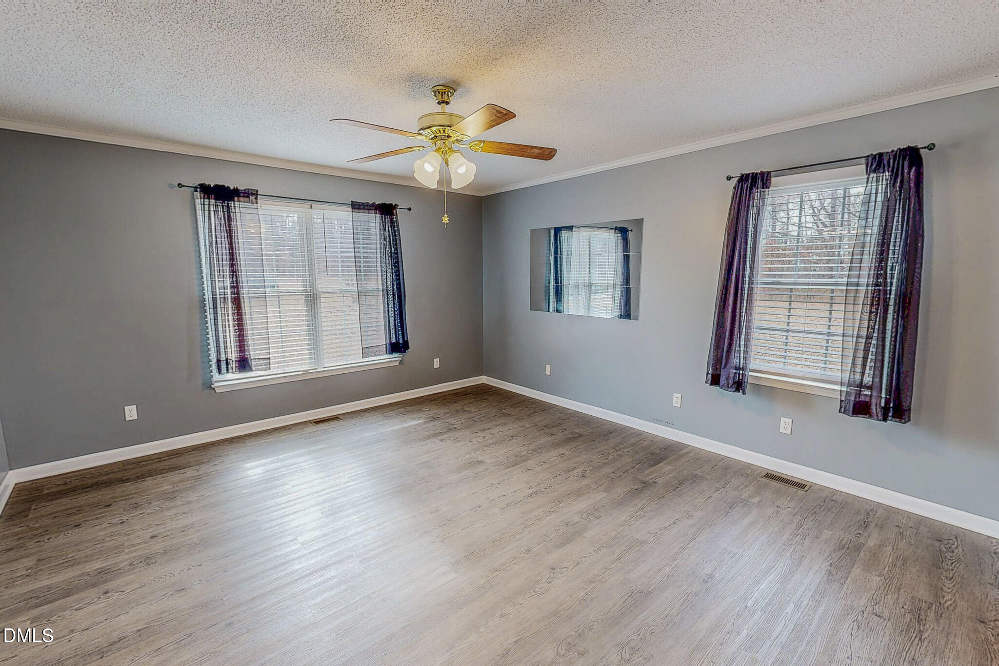 111 Fox Crossing Drive Roxboro, NC 27574 - Photo 12 of 25 a view of an empty room with a window and wooden floor