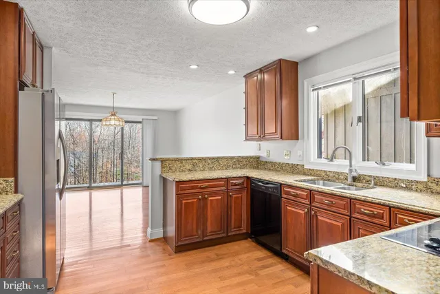 a spacious bathroom with a granite countertop sink and a mirror