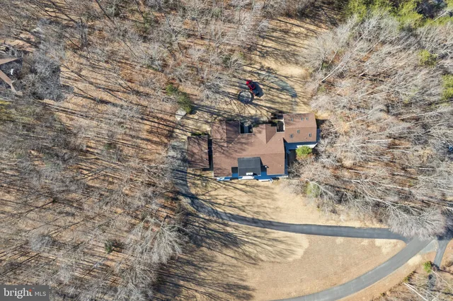 a view of a house with a dry trees