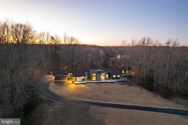 a view of a house with a yard and sitting area