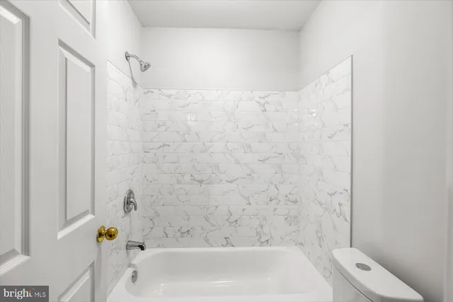 a bathroom with a bathtub and shower