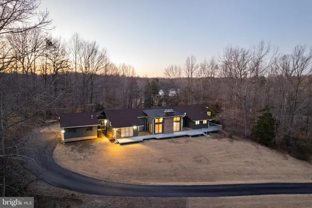 a view of a swimming pool with an outdoor seating and trees