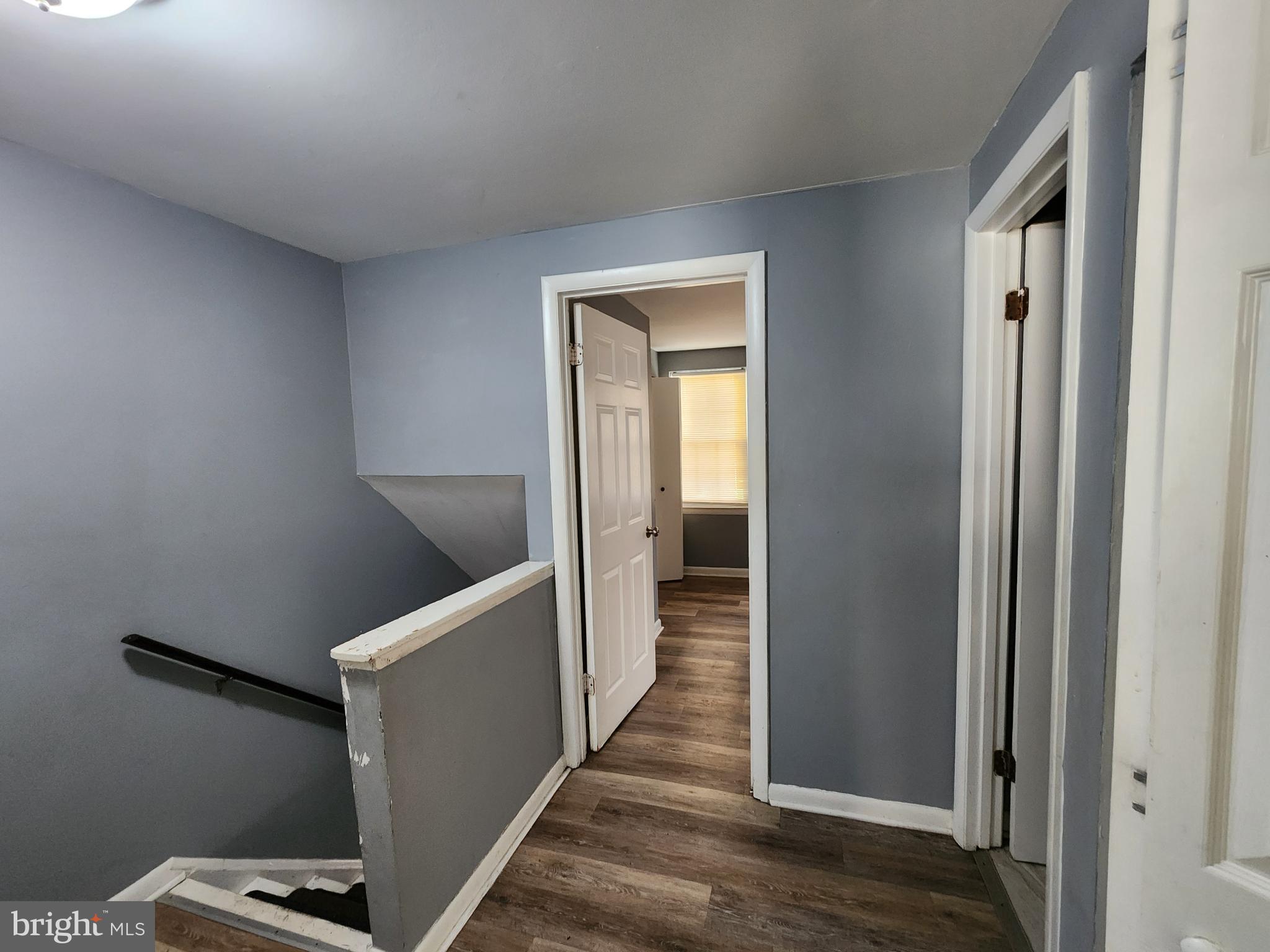 819 Aisquith Street Baltimore, MD 21202 - Photo 12 of 24 a view of a hallway with wooden floor