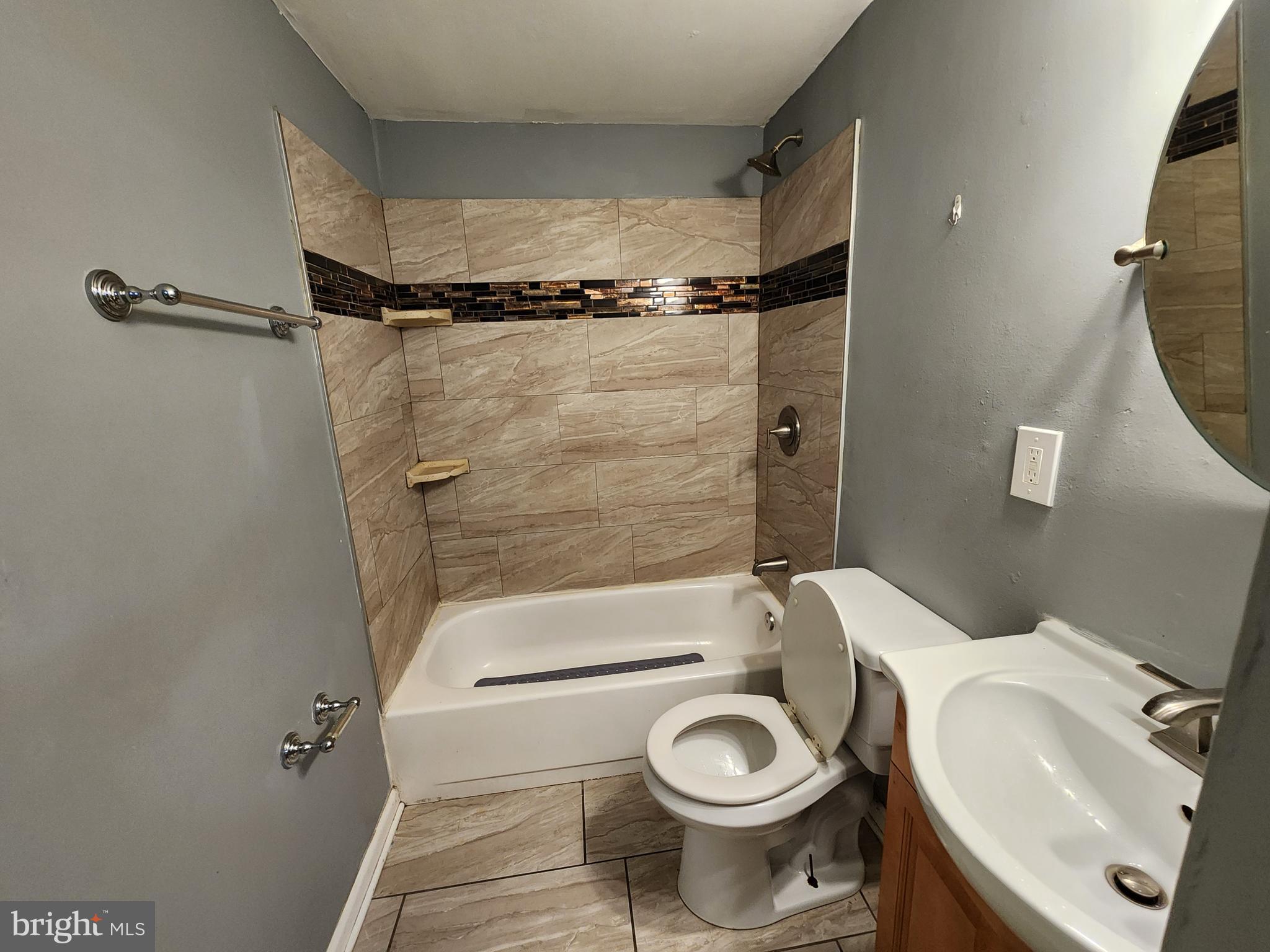 819 Aisquith Street Baltimore, MD 21202 - Photo 17 of 24 a bathroom with a sink a toilet a mirror and shower