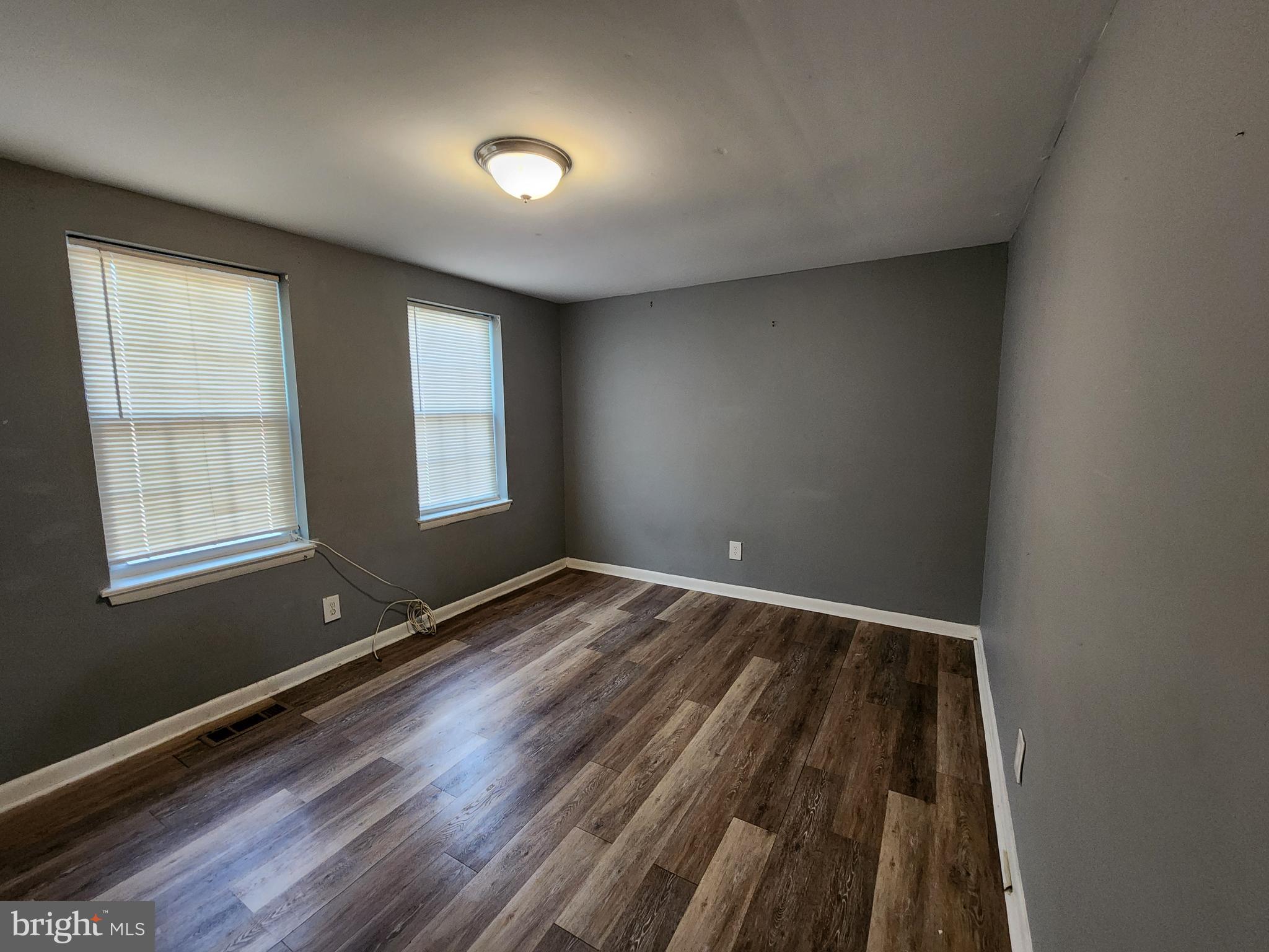 819 Aisquith Street Baltimore, MD 21202 - Photo 18 of 24 a view of room with window and wooden floor