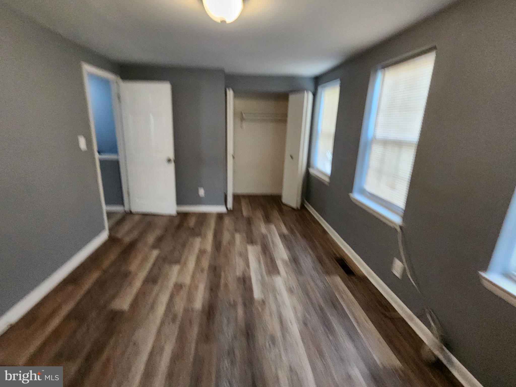 819 Aisquith Street Baltimore, MD 21202 - Photo 19 of 24 a view of a room with wooden floor and window