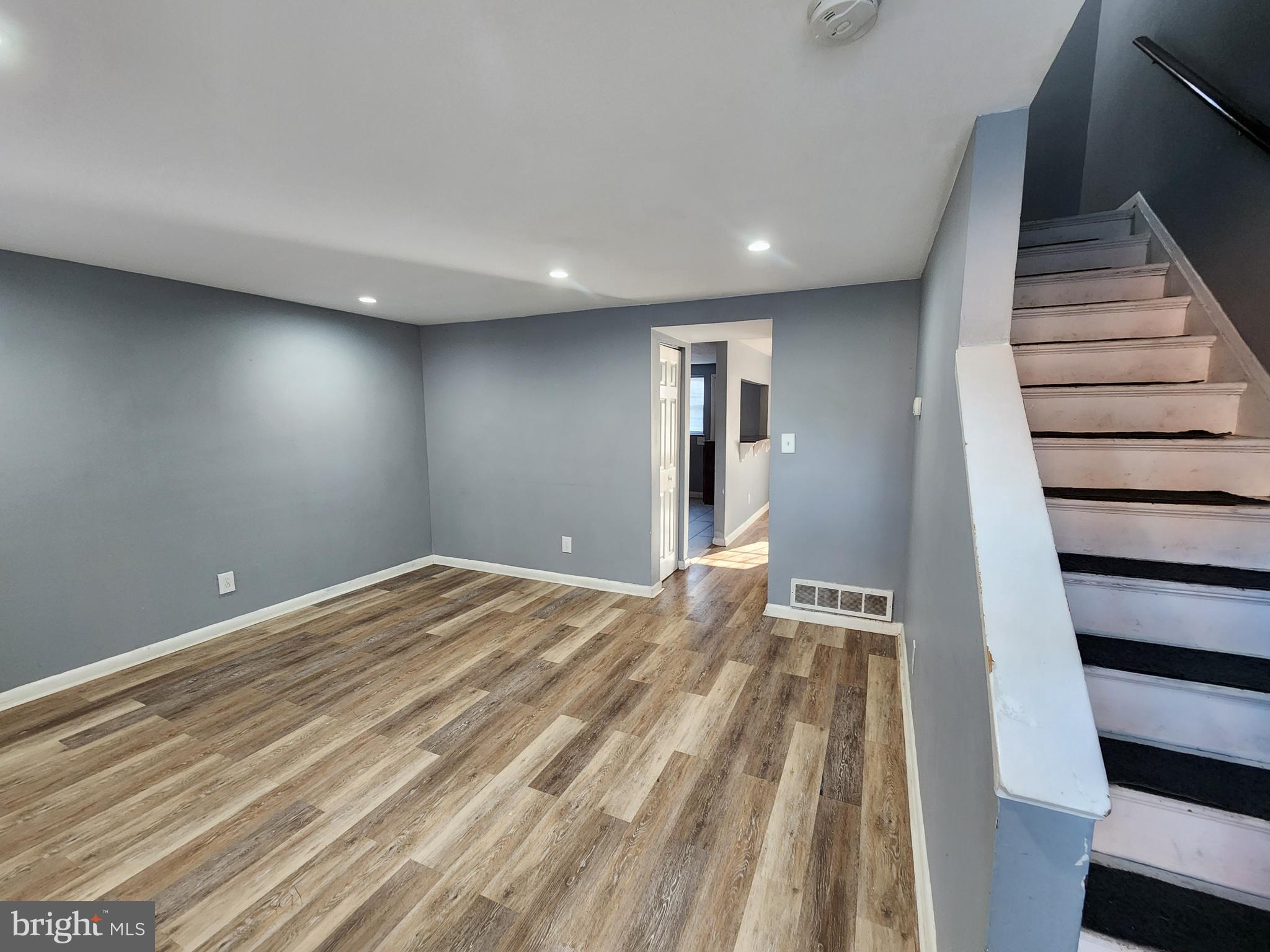 819 Aisquith Street Baltimore, MD 21202 - Photo 2 of 24 a view of empty room with wooden floor and entryway