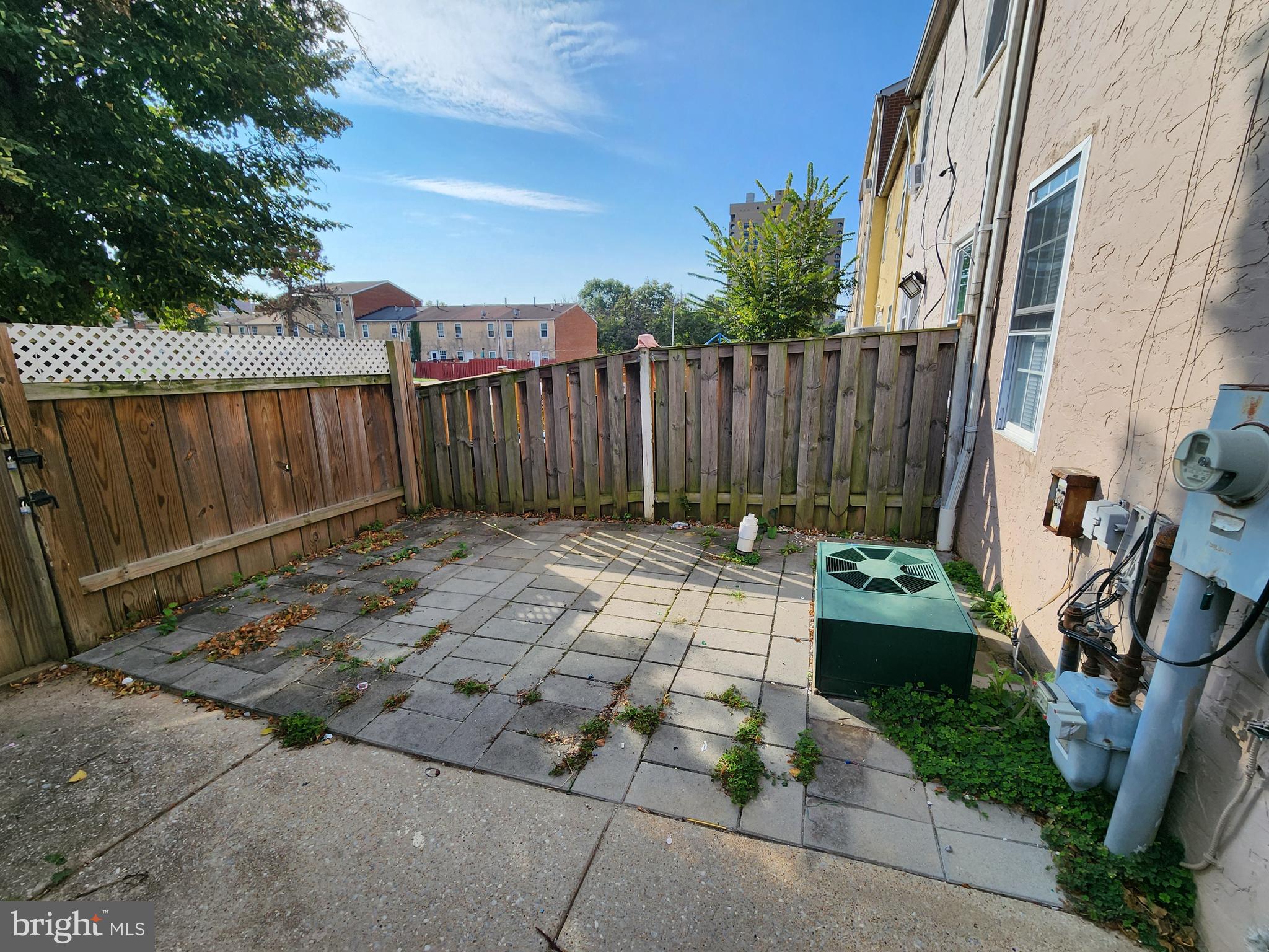 819 Aisquith Street Baltimore, MD 21202 - Photo 21 of 24 a view of a backyard with a chair and potted plants
