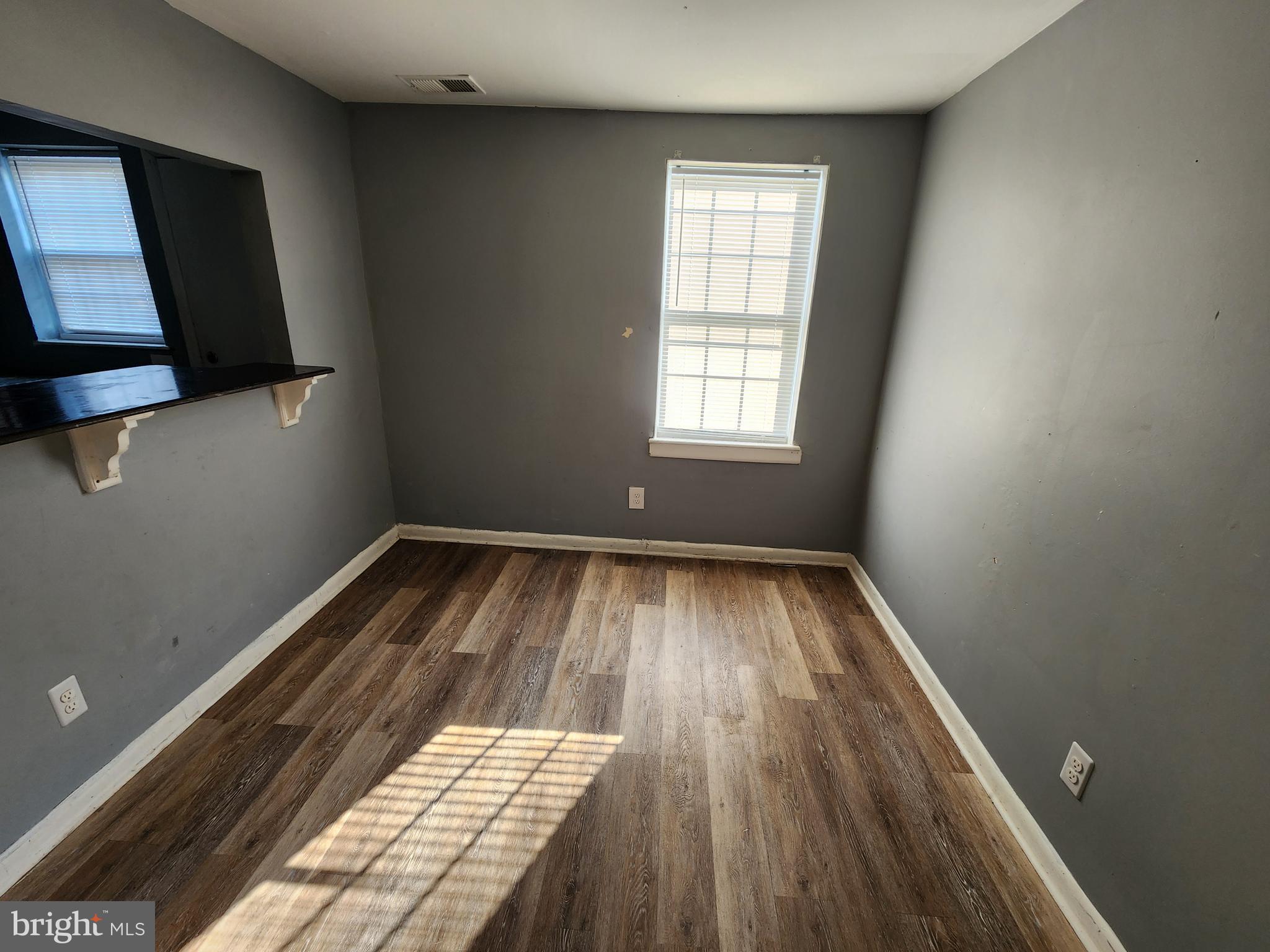 819 Aisquith Street Baltimore, MD 21202 - Photo 9 of 24 wooden floor in an empty room with a window