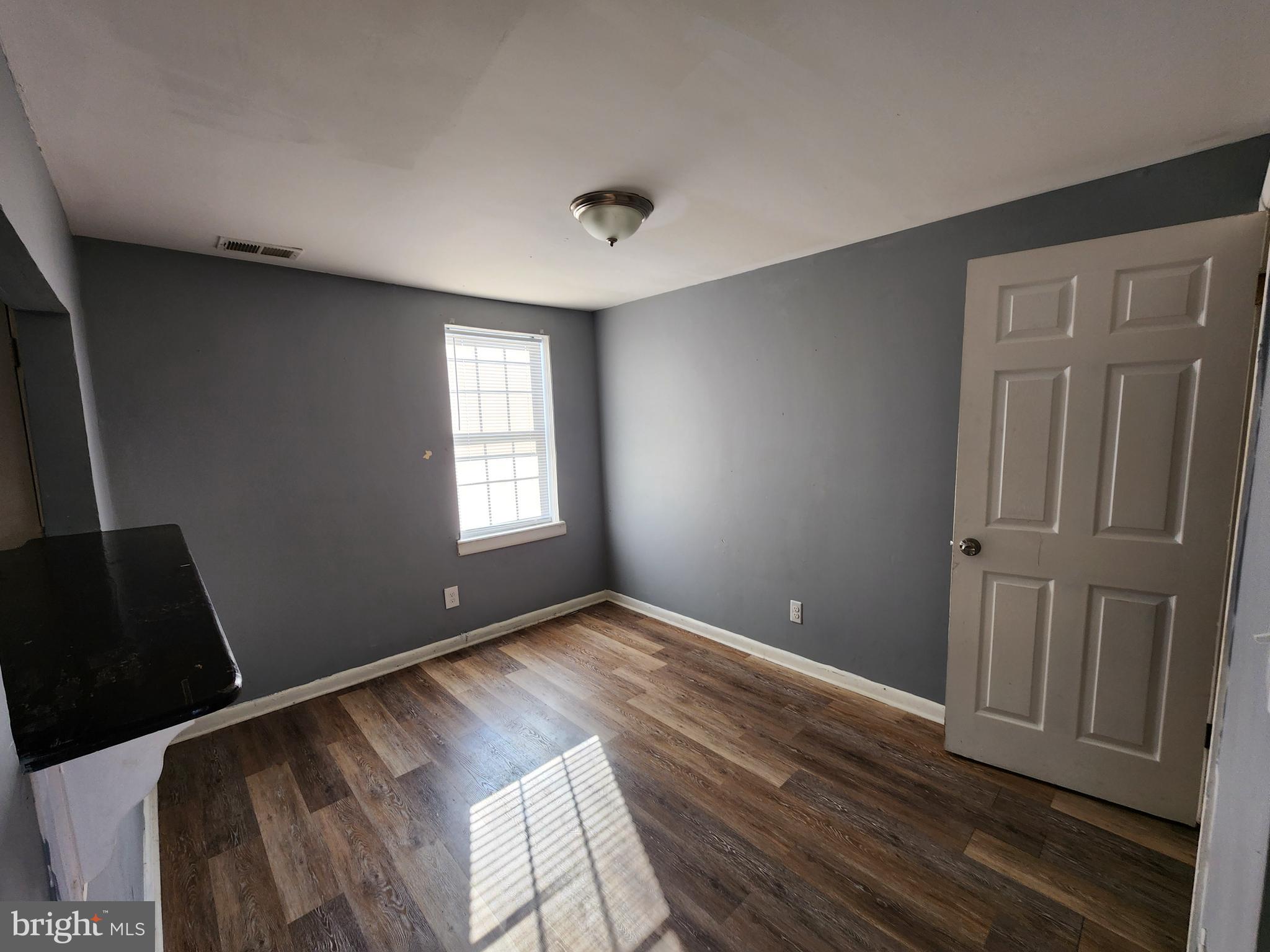819 Aisquith Street Baltimore, MD 21202 - Photo 10 of 24 a view of empty room with wooden floor and fan