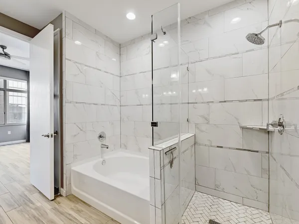 a bathroom with a bathtub and a shower