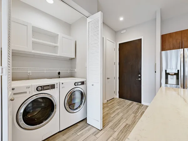 a view of a hallway with washer and dryer
