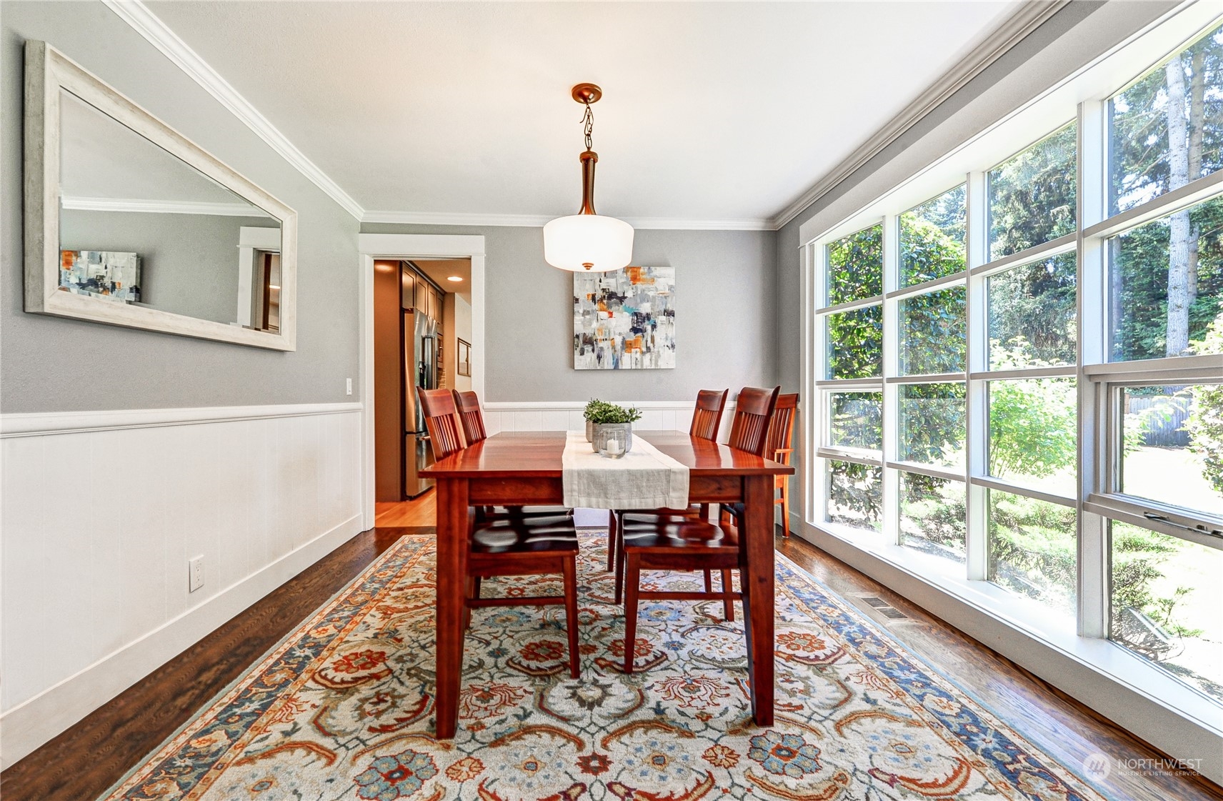 25 Cascade Key Bellevue, WA 98006 - Photo 6 of 33 a dining room with wooden floor a chandelier a wooden table and chairs