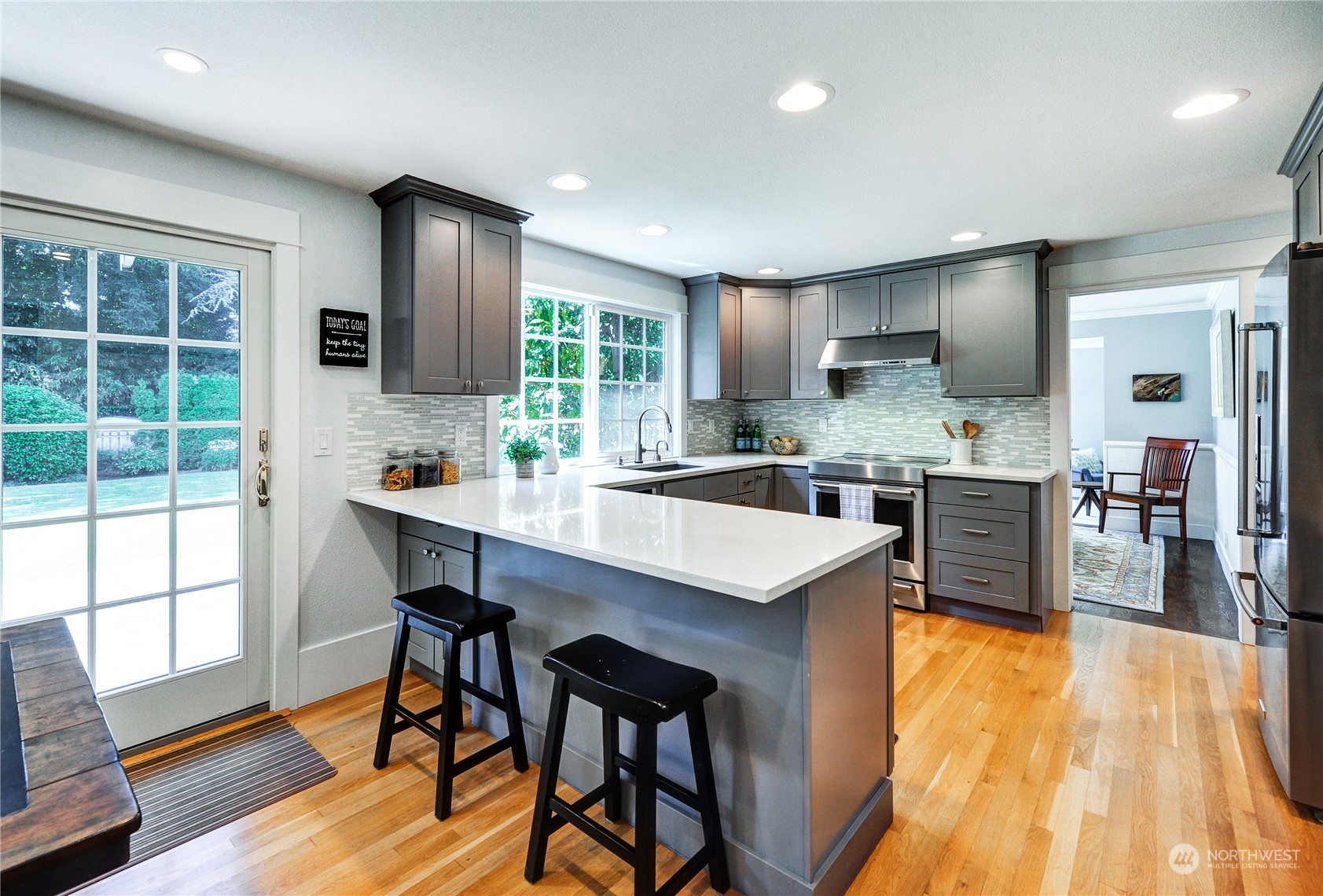 25 Cascade Key Bellevue, WA 98006 - Photo 8 of 33 a kitchen with stainless steel appliances granite countertop table chairs sink and cabinets