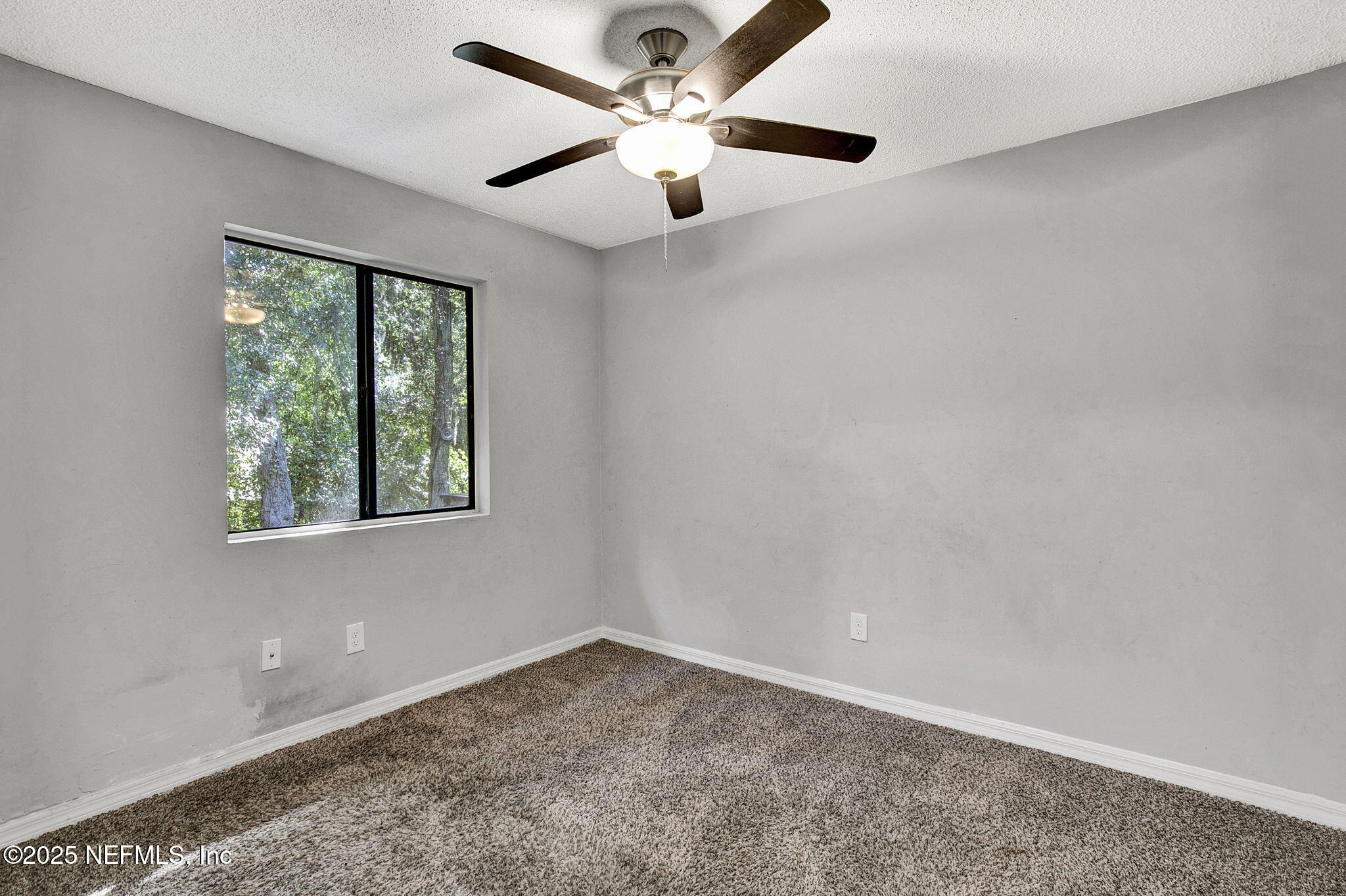 591 Julia Street St. Augustine, FL 32084 - Photo 14 of 19 an empty room with a window and a fan