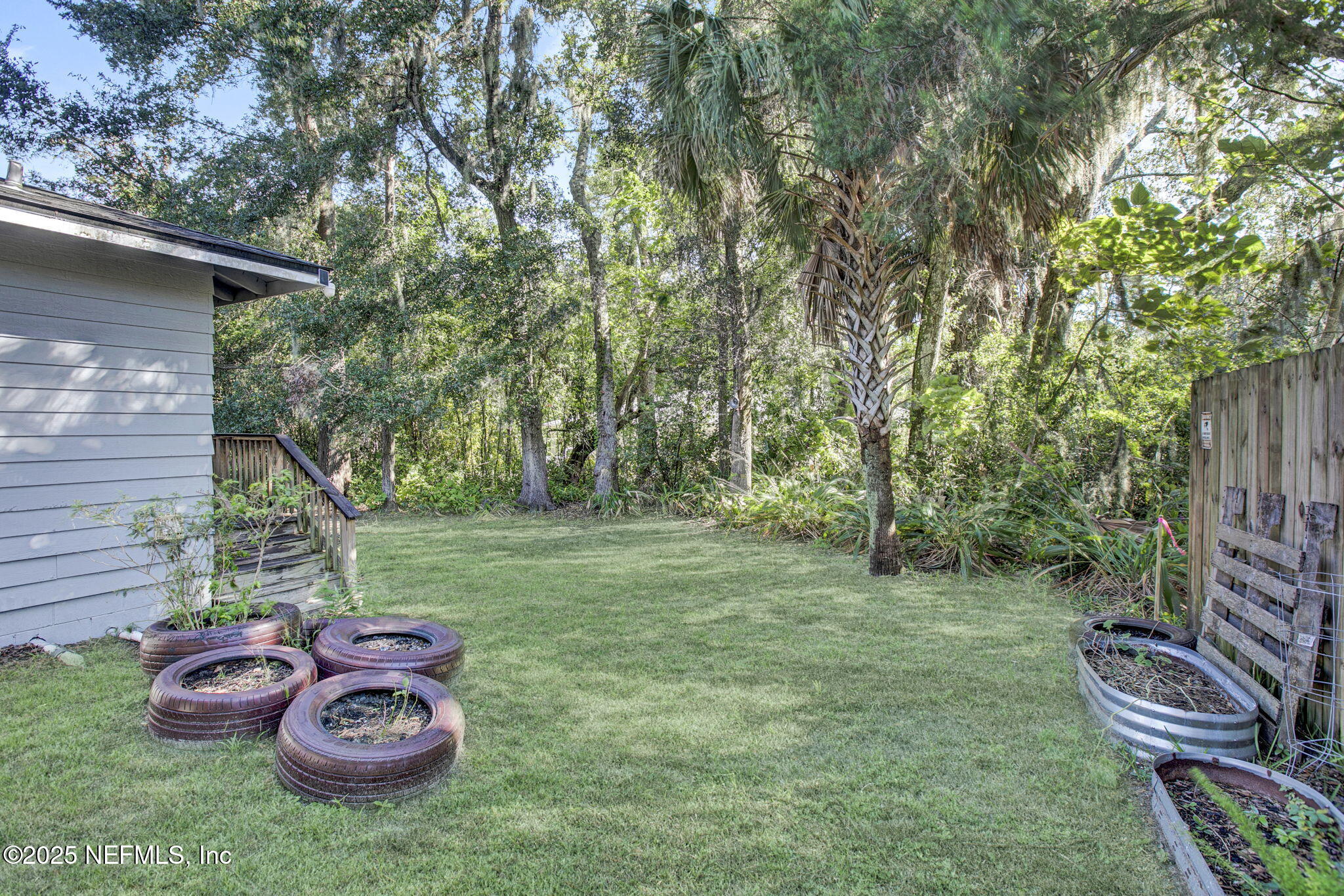 591 Julia Street St. Augustine, FL 32084 - Photo 19 of 19 a view of a backyard with table and chairs and a fire pit