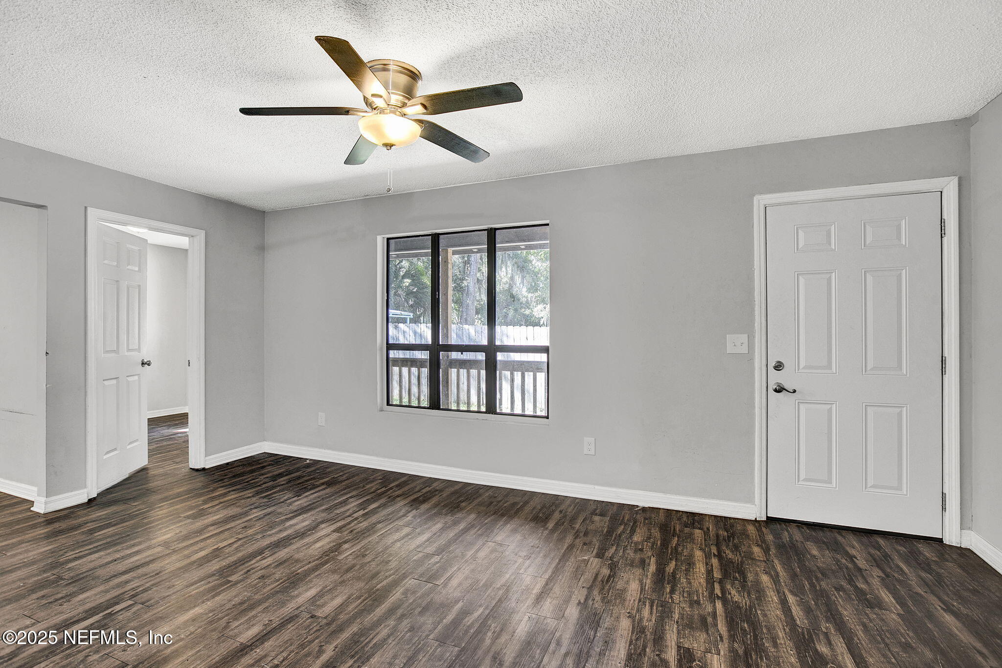 591 Julia Street St. Augustine, FL 32084 - Photo 4 of 19 a view of an empty room with wooden floor and a window