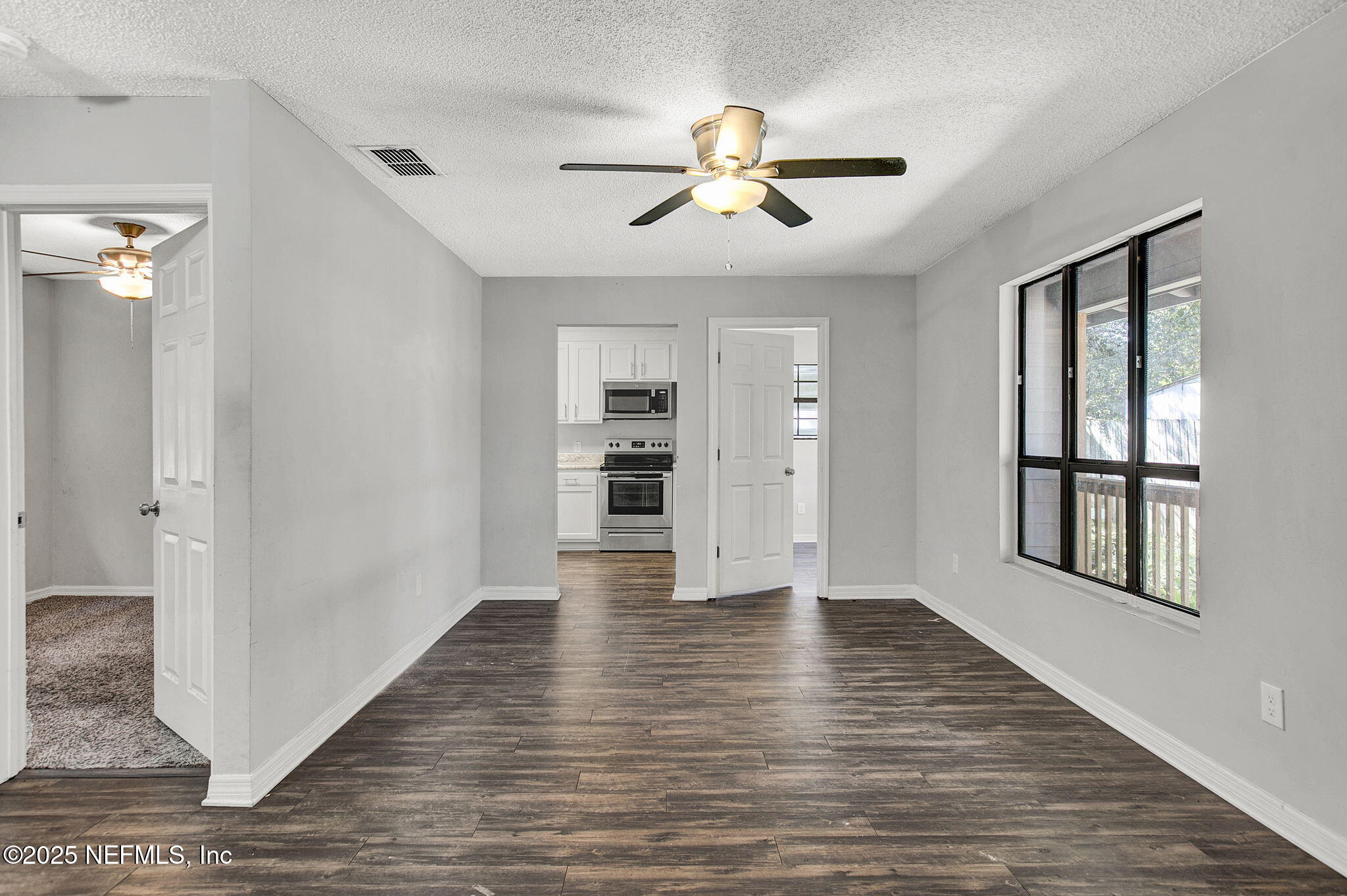 591 Julia Street St. Augustine, FL 32084 - Photo 6 of 19 a view of an empty room with a window and wooden floor