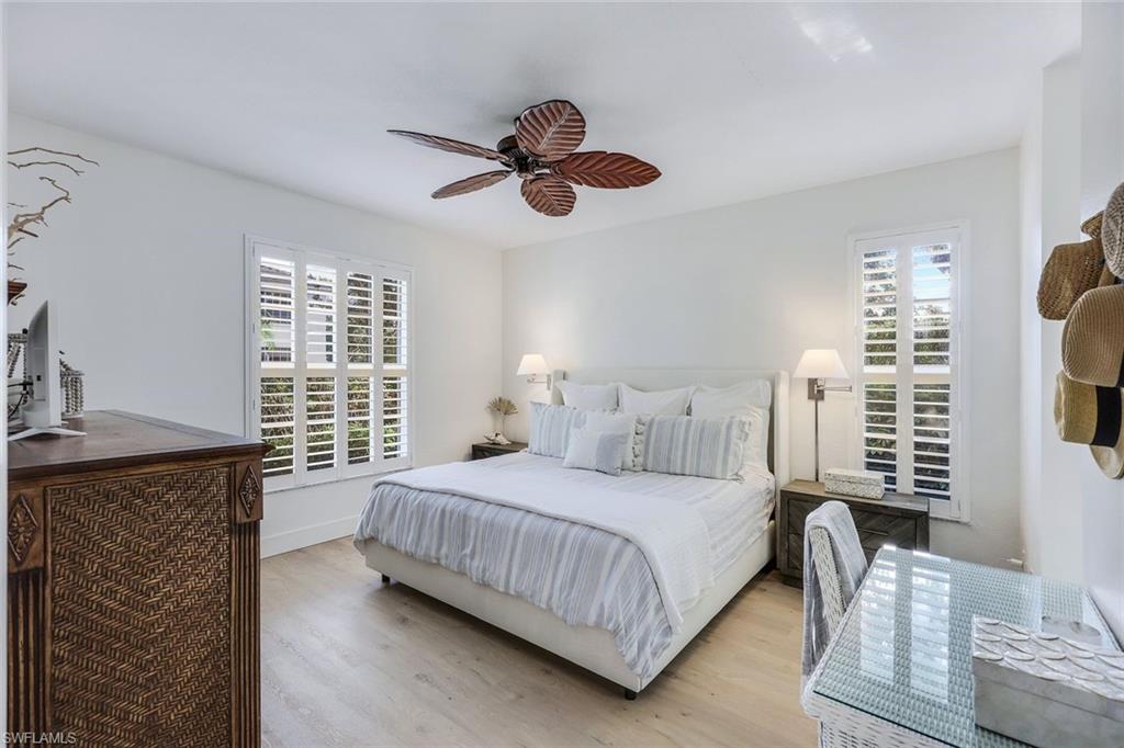7108 Barrington Circle Naples, FL 34108 - Photo 13 of 25 a bedroom with a bed dresser and a window