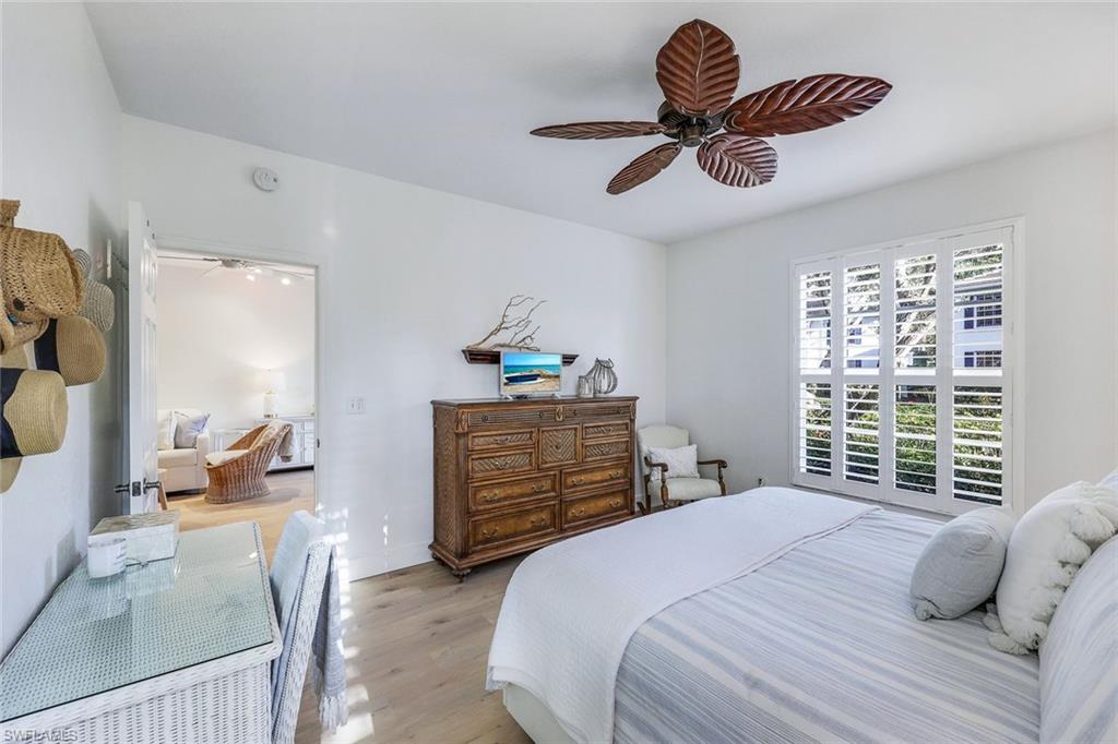 7108 Barrington Circle Naples, FL 34108 - Photo 14 of 25 a bedroom with a bed and a chandelier