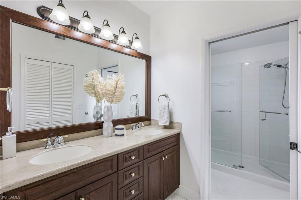 7108 Barrington Circle Naples, FL 34108 - Photo 15 of 25 a bathroom with a double vanity sink mirror and double