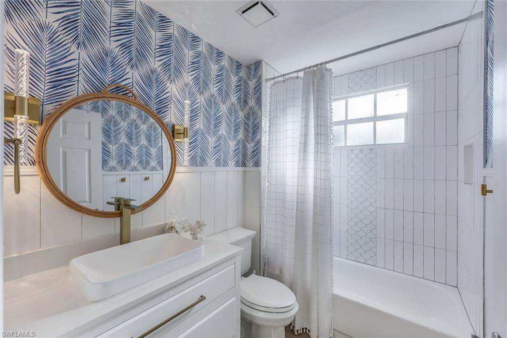 7108 Barrington Circle Naples, FL 34108 - Photo 19 of 25 a bathroom with a toilet a sink and mirror