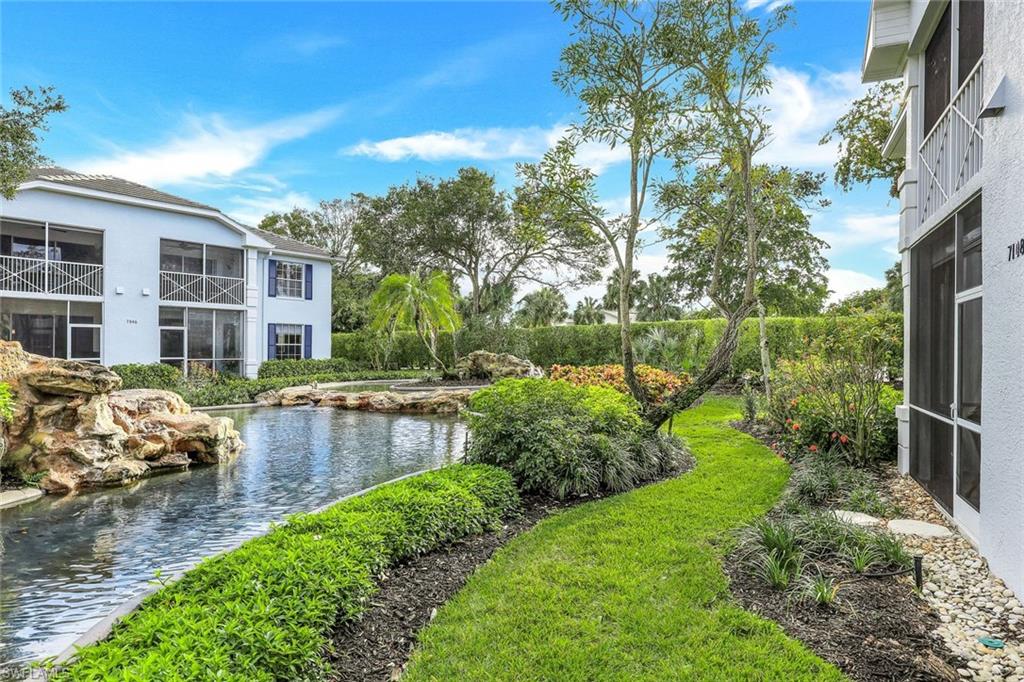 7108 Barrington Circle Naples, FL 34108 - Photo 24 of 25 a view of a house with backyard and a garden