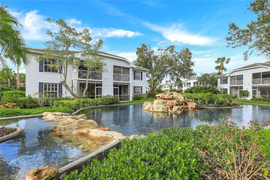 7108 Barrington Circle Naples, FL 34108 - Photo 25 of 25 a view of a lake with a house in the background