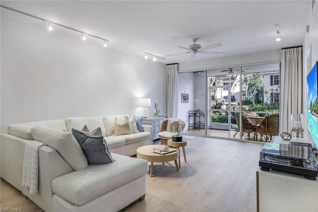 7108 Barrington Circle Naples, FL 34108 - Photo 4 of 25 a living room with furniture and a flat screen tv