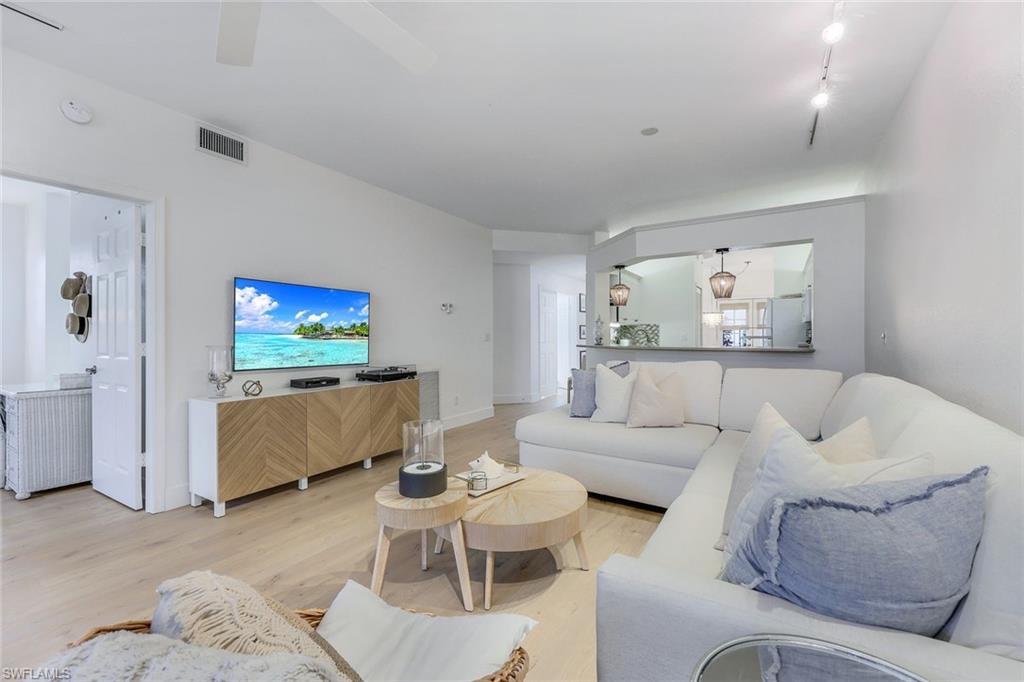 7108 Barrington Circle Naples, FL 34108 - Photo 7 of 25 a living room with furniture and a flat screen tv