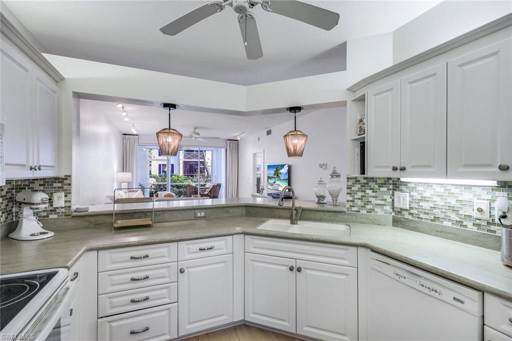 7108 Barrington Circle Naples, FL 34108 - Photo 8 of 25 a kitchen with sink and cabinets