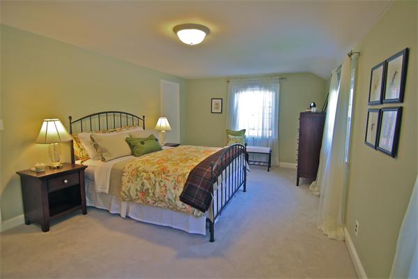 552 South Border Road Winchester, MA 01890 - Photo 12 of 19 a spacious bedroom with a bed and dresser with mirror