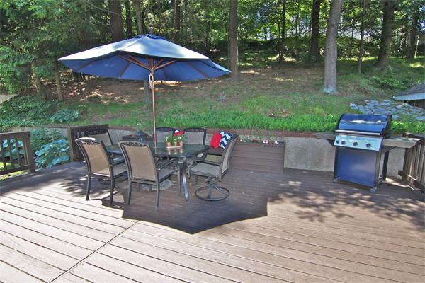 552 South Border Road Winchester, MA 01890 - Photo 4 of 19 a view of a patio with table and chairs under an umbrella