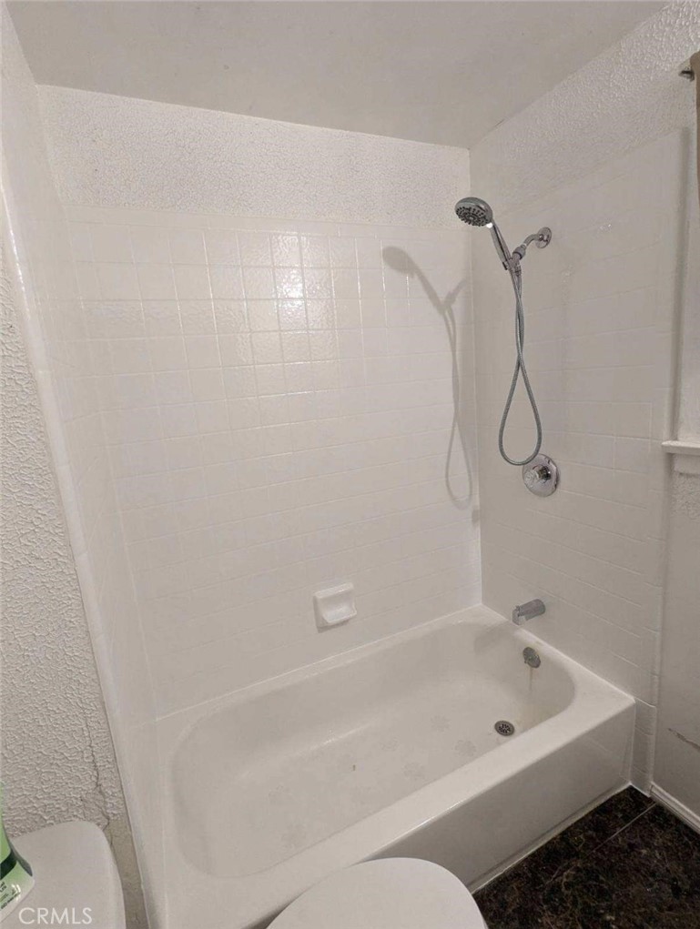 3076 Lemon Street Riverside, CA 92501 - Photo 12 of 28 a bathroom with a bathtub and shower