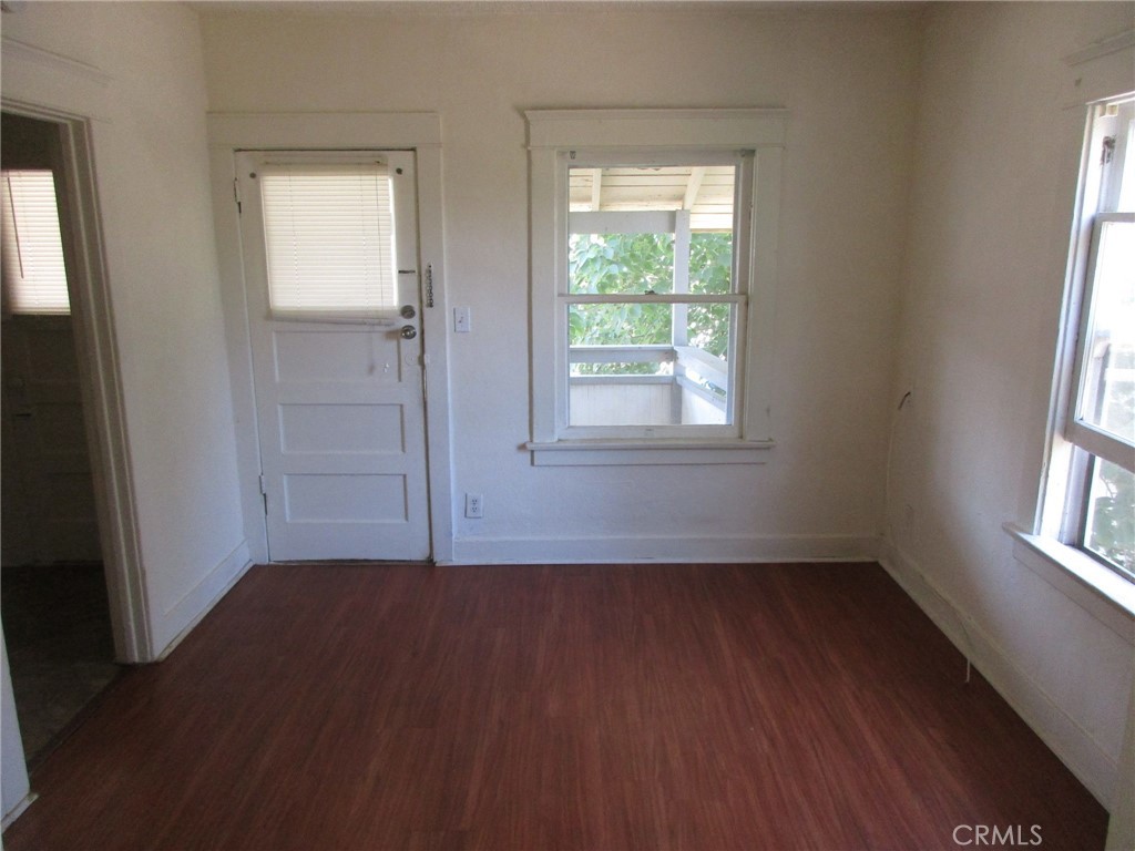 3076 Lemon Street Riverside, CA 92501 - Photo 13 of 28 an empty room with wooden floor and windows