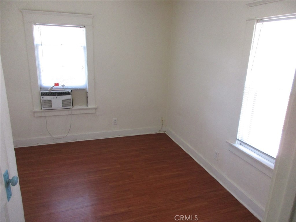 3076 Lemon Street Riverside, CA 92501 - Photo 16 of 28 an empty room with wooden floor and windows