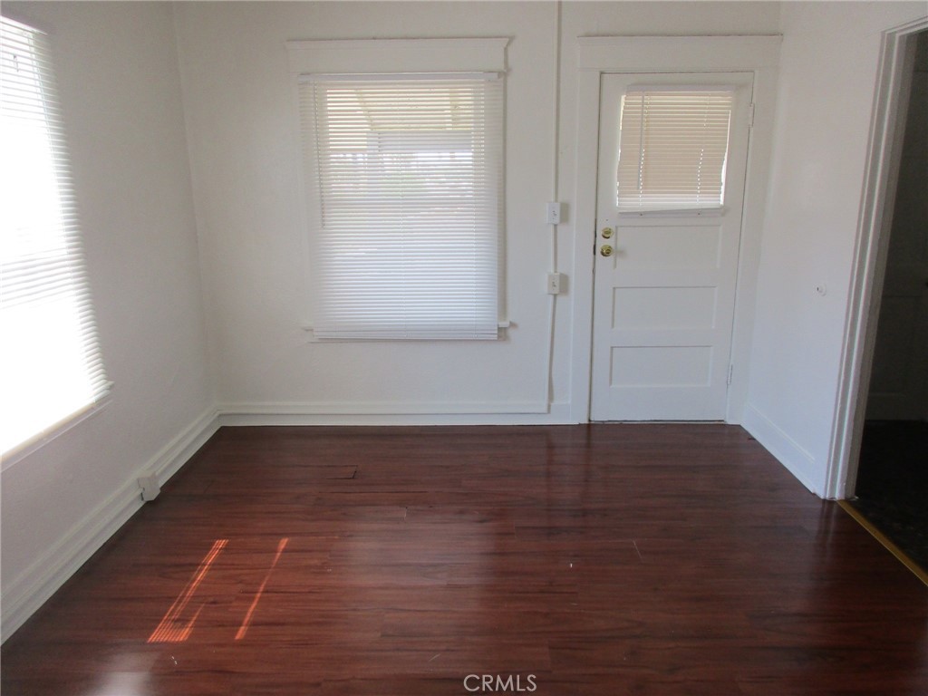3076 Lemon Street Riverside, CA 92501 - Photo 21 of 28 a view of an empty room with wooden floor and a window