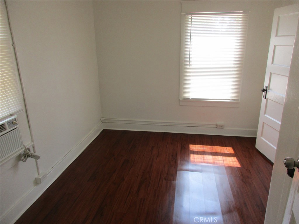 3076 Lemon Street Riverside, CA 92501 - Photo 22 of 28 a view of an empty room with wooden floor and a window