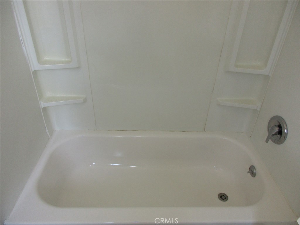 3076 Lemon Street Riverside, CA 92501 - Photo 24 of 28 a close up of a bathtub in a bathroom