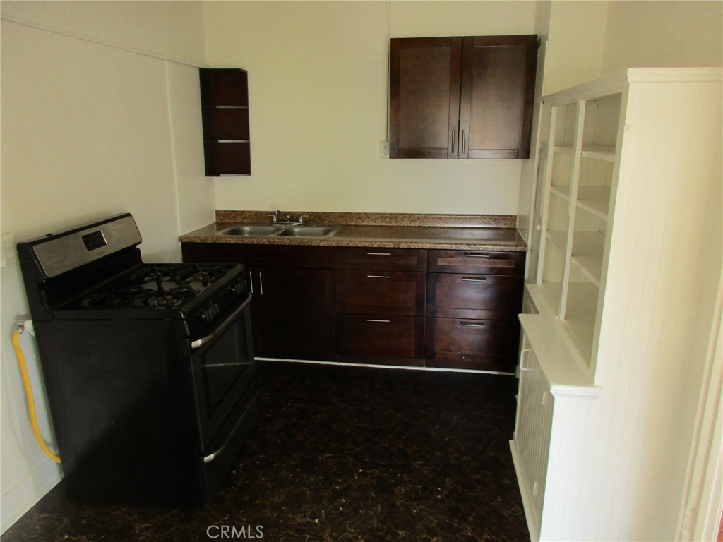 3076 Lemon Street Riverside, CA 92501 - Photo 26 of 28 a bathroom with a sink and a mirror