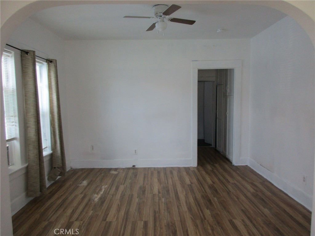 3076 Lemon Street Riverside, CA 92501 - Photo 5 of 28 an empty room with wooden floor and a window