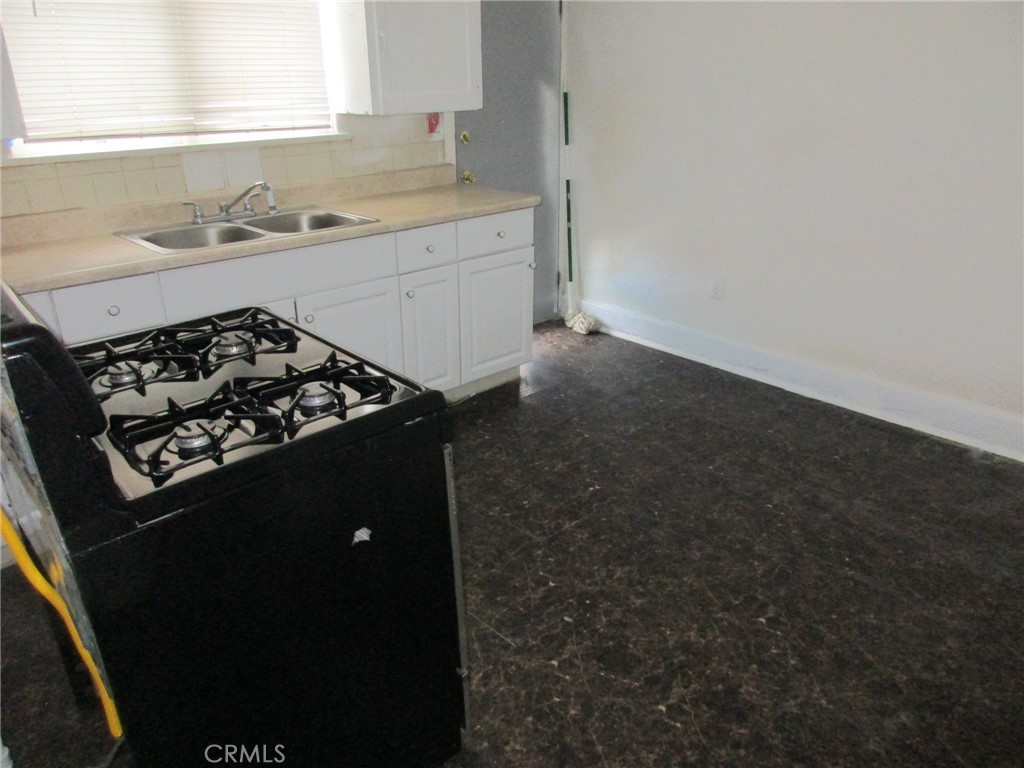 3076 Lemon Street Riverside, CA 92501 - Photo 9 of 28 a kitchen with a stove and a window