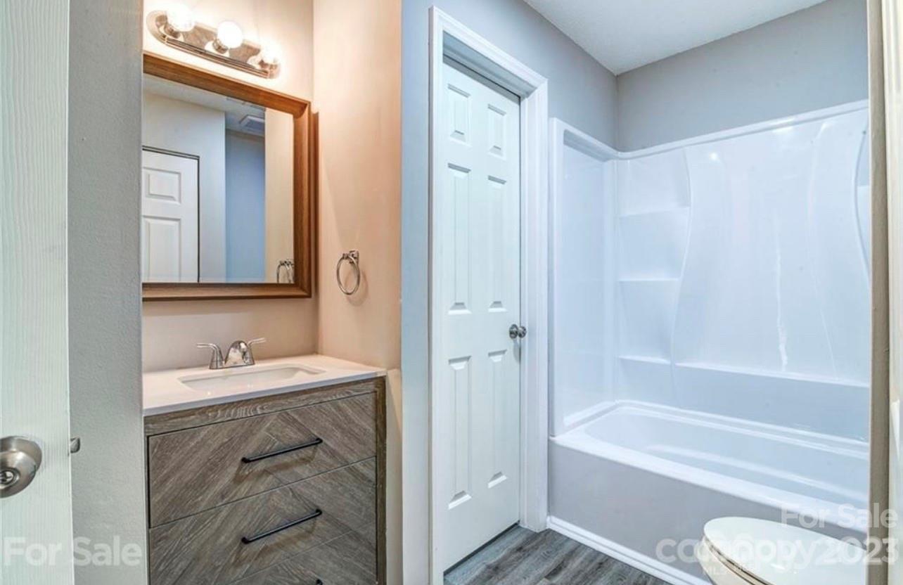 8179 Cedar Glen Drive Charlotte, NC 28212 - Photo 5 of 9 a bathroom with a sink a toilet and a bathtub