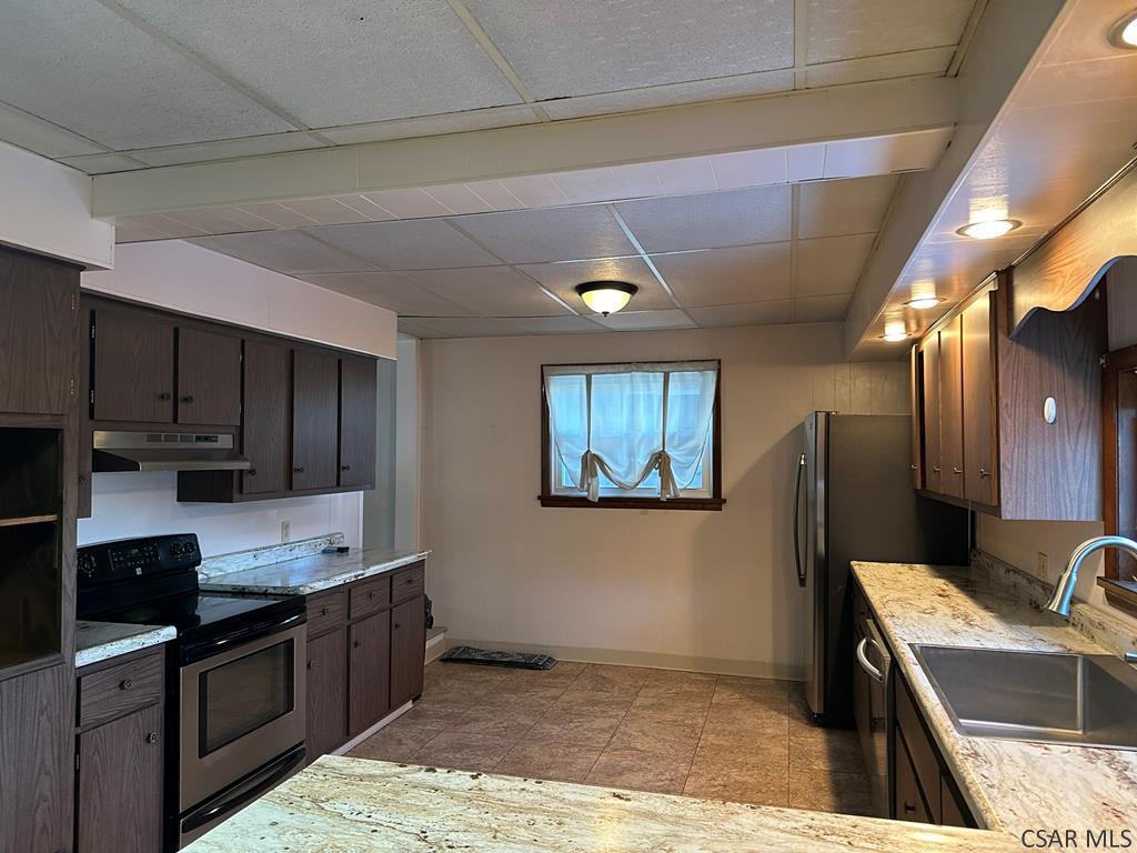 312 12th Street Windber, PA 15963 - Photo 4 of 24 a kitchen with stainless steel appliances granite countertop a refrigerator a stove top oven a sink and dishwasher