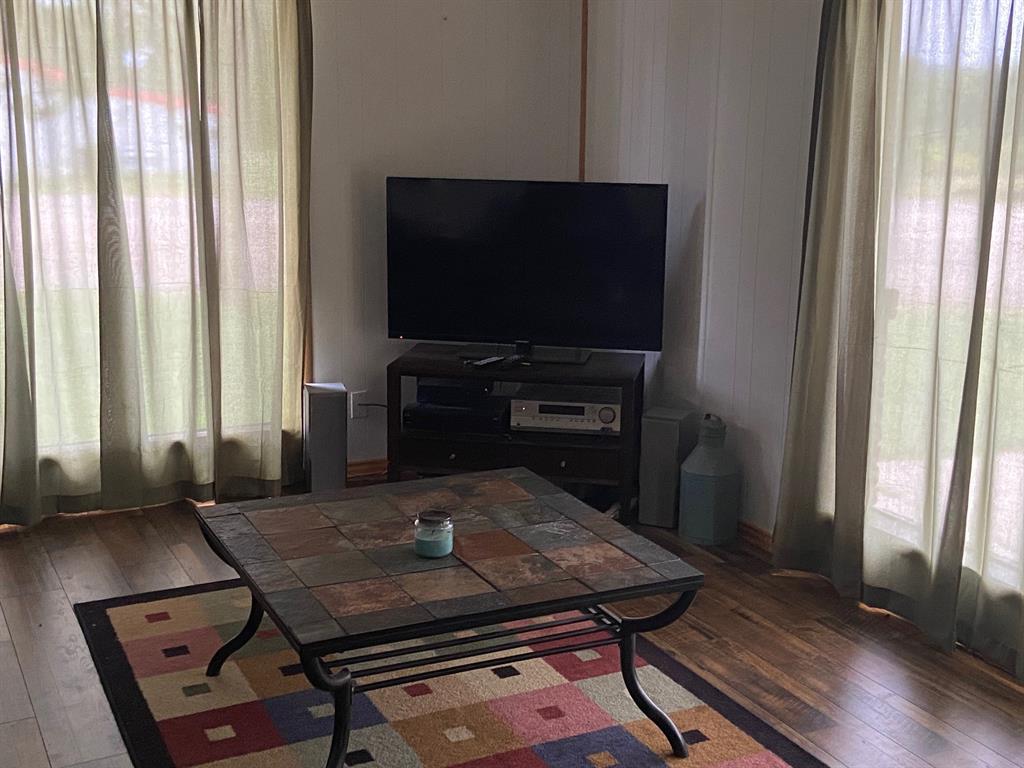 104 County Road 1296 Morgan, TX 76671 - Photo 2 of 27 a living room with a flat screen tv and outdoor view