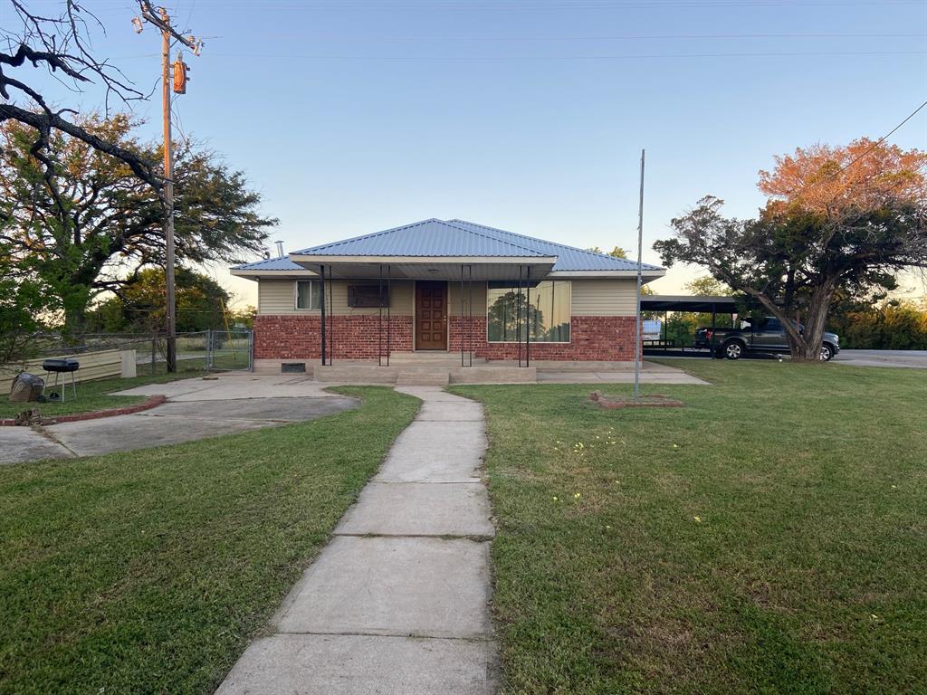 104 County Road 1296 Morgan, TX 76671 - Photo 21 of 27 a front view of a house with a yard and trees