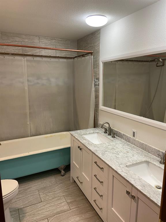 104 County Road 1296 Morgan, TX 76671 - Photo 3 of 27 a bathroom with a granite countertop sink and a mirror