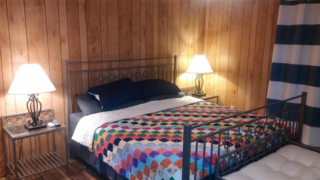 104 County Road 1296 Morgan, TX 76671 - Photo 5 of 27 a bedroom with a bed and a lamp on dresser