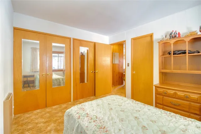 a spacious bedroom with a bed and a large window