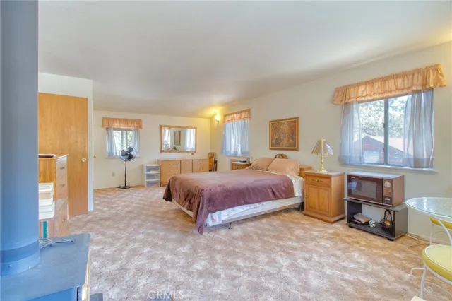 a spacious bedroom with a bed and window